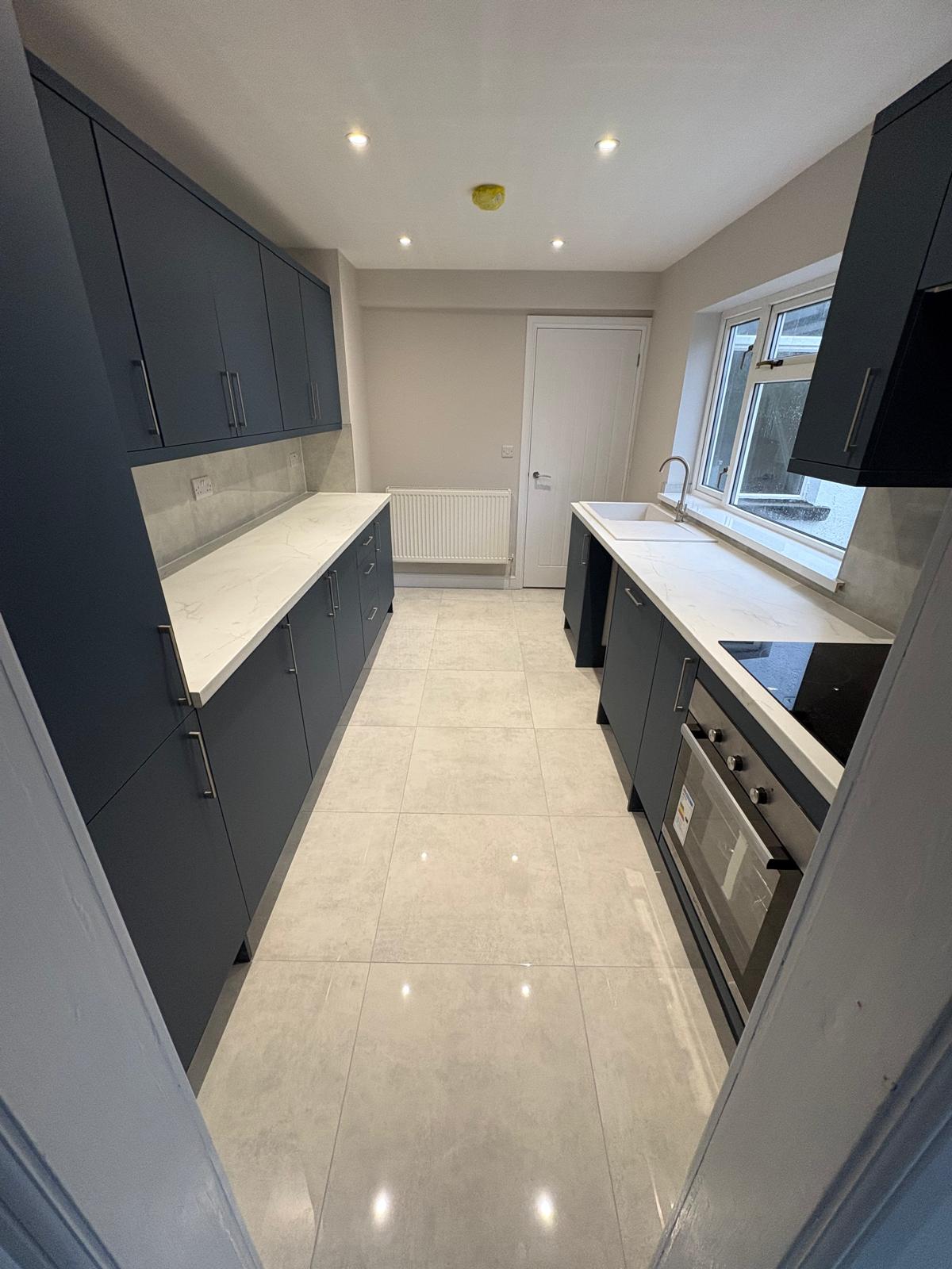 Finished kitchen with island and marble worktops